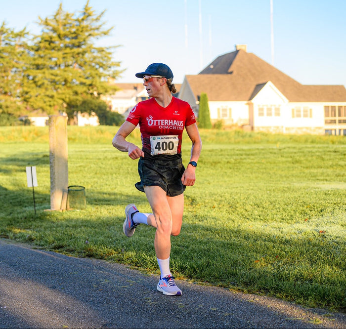 Person running on a path with a red Otterhaus shirt and number 400 visible